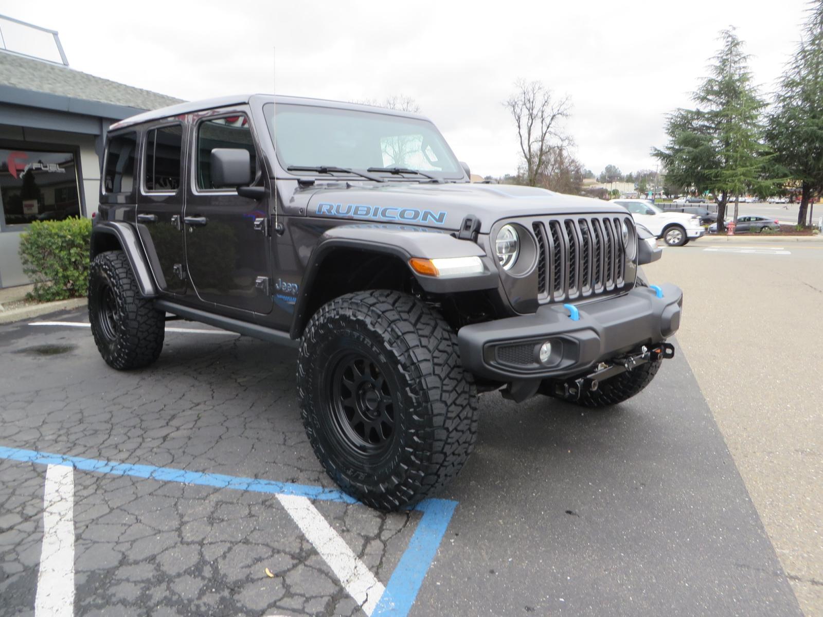 2021 CHARCOAL /BLACK Jeep Wrangler Unlimited Rubicon 4XE 4d SUV 4wd (1C4JJXR60MW) with an 2.0L L4 DOHC 16V TURBO engine, automatic transmission, located at 2630 Grass Valley Highway, Auburn, CA, 95603, (530) 508-5100, 38.937893, -121.095482 - 4XE Rubicon sitting on a Zone offroad suspension system, Fox shocks, 37" Toyo RT trail tires, 17" Method Race wheels, Teraflex Hd tire carrier, and Flat tow ready. - Photo #2